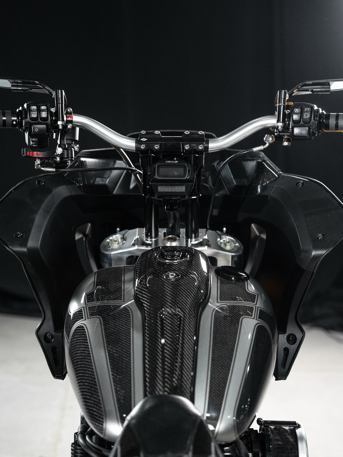 The rider’s view: bars, central instruments and carbon-textured bodywork.